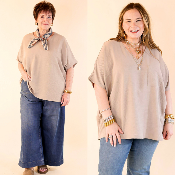 This cute top includes short drop sleeves, a v neckline, a front pocket, and an oversized fit. Available in sizes small through plus size. 