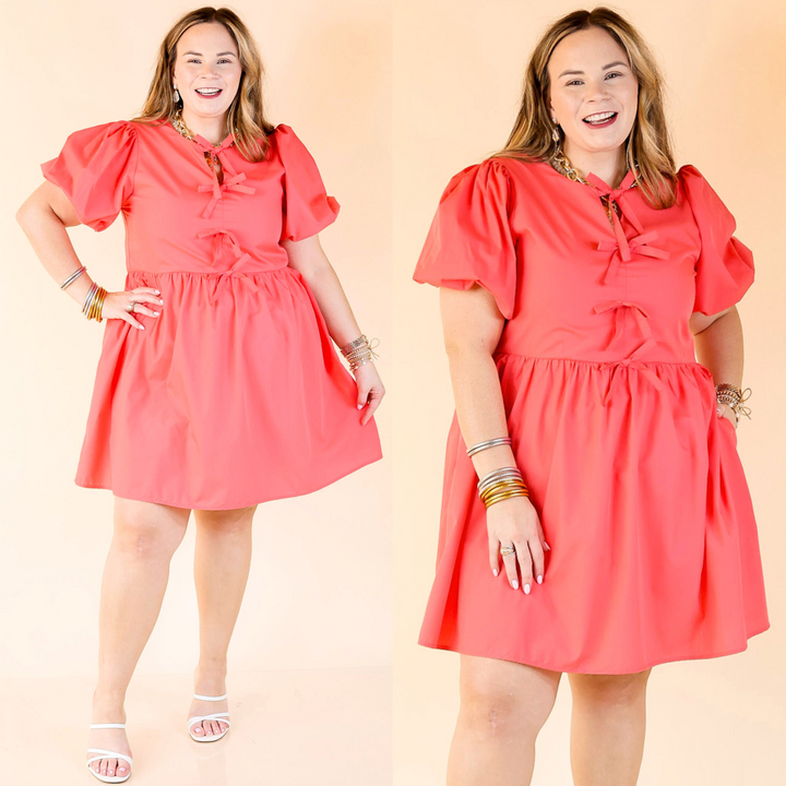 Short dress with short puff sleeves. Dress is a solid coral dress. 