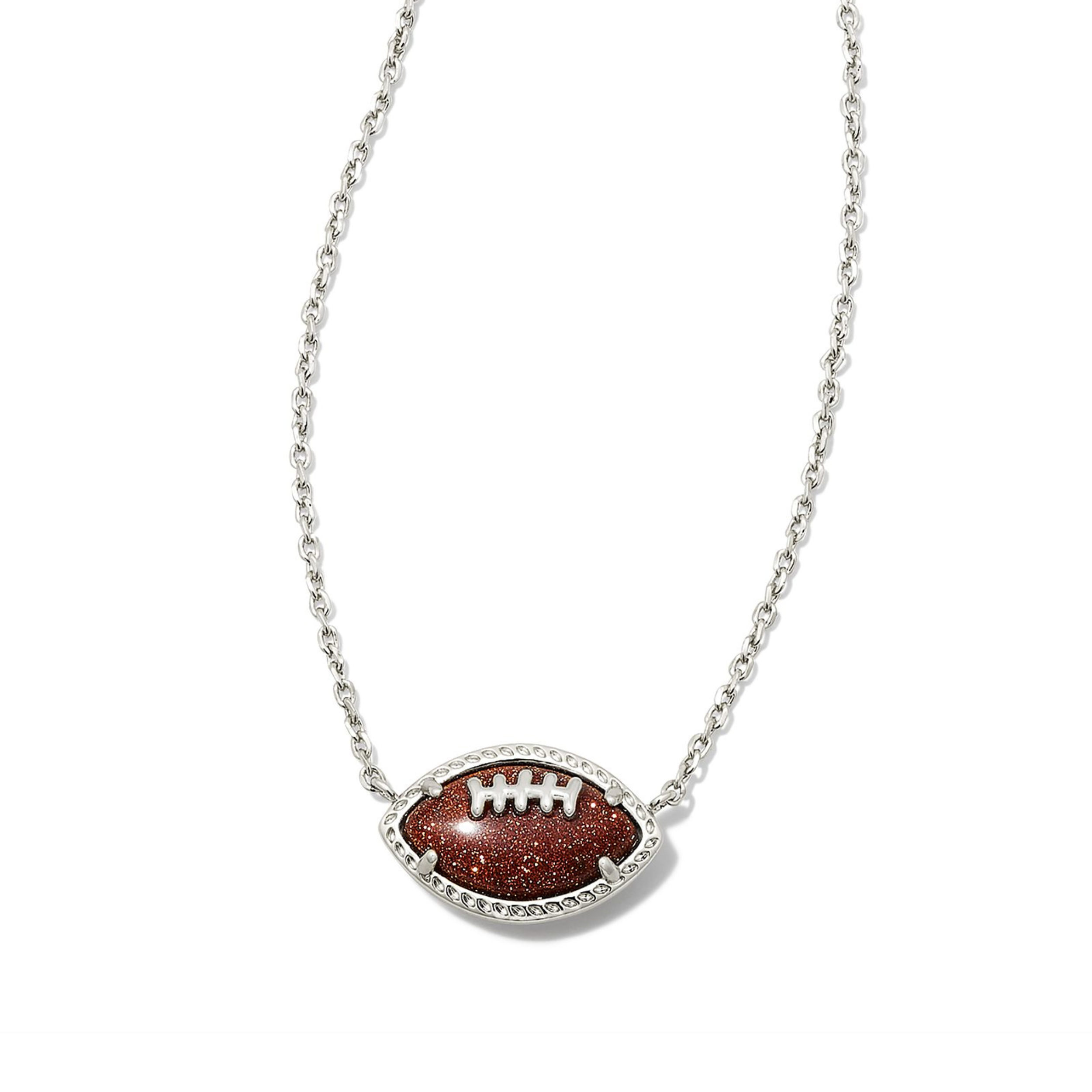Pictured on a white background is a silver necklace with a brown football pendant.  