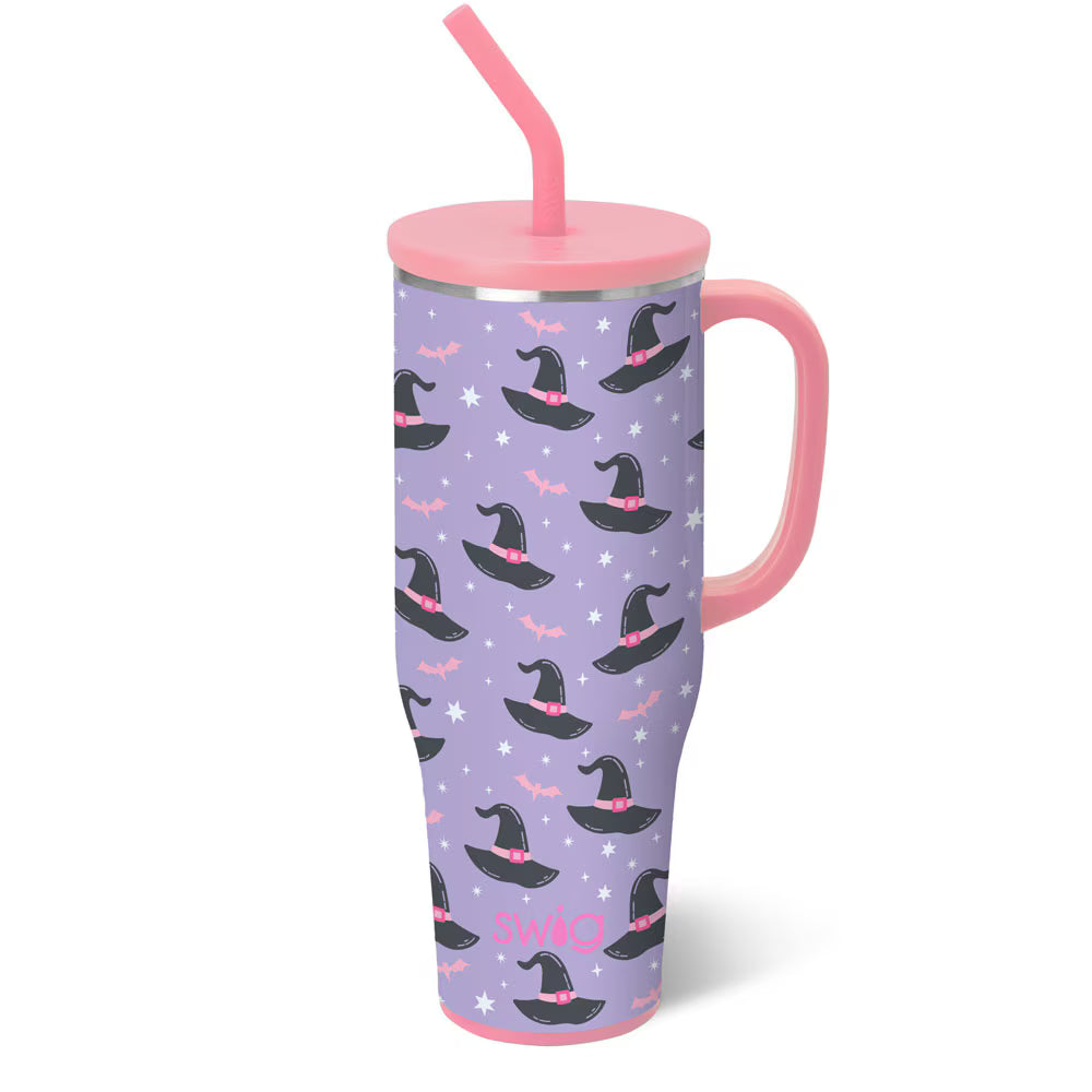 Purple tumbler with witch hats and pink straw on a white background
