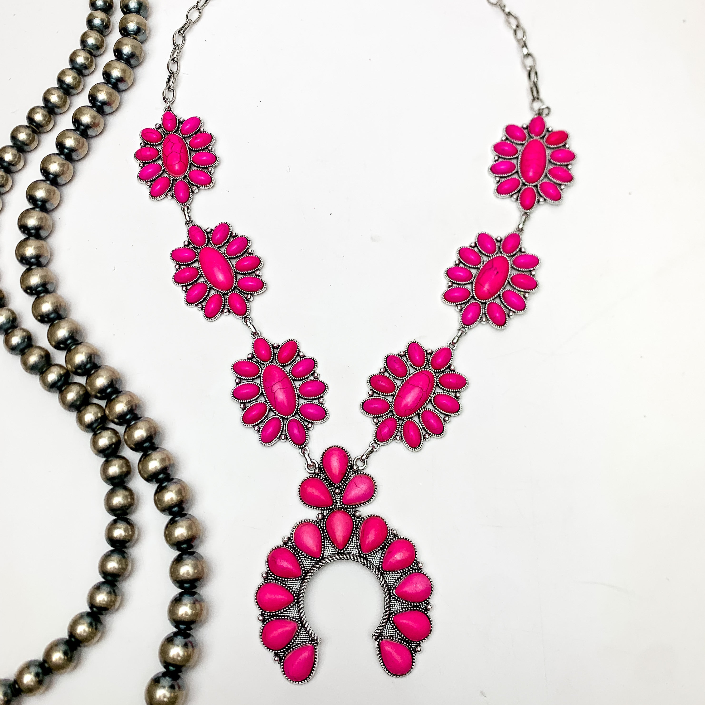 Squash Necklace with Oval Flowers in Silver Tone and fuchsia pink. This necklace is pictured on a white background with Navajo pearls on the left side.