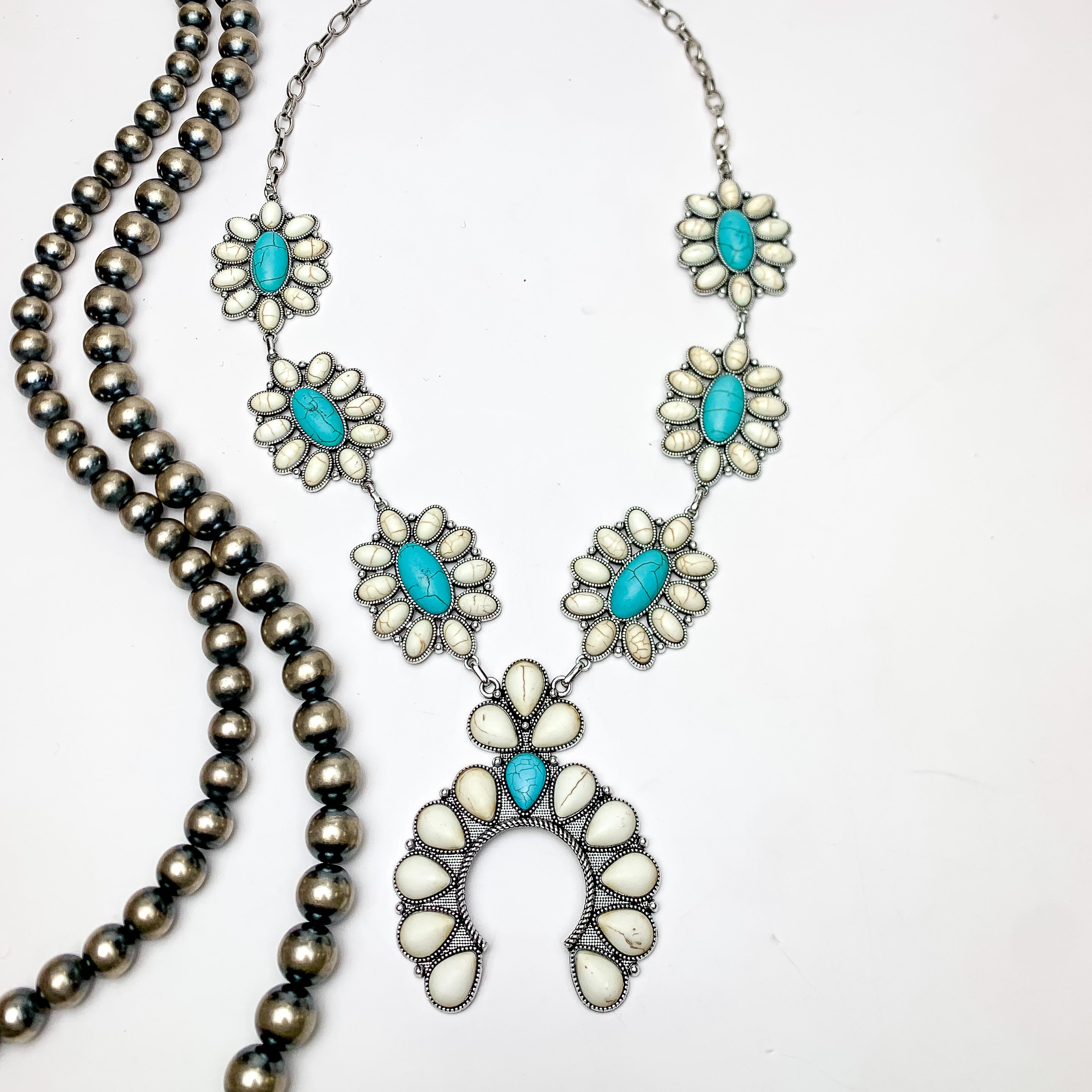 Squash Necklace with Oval Flowers in Silver Tone, Turquoise, and White. This necklace is pictured on a white background with Navajo pearls on the left side.