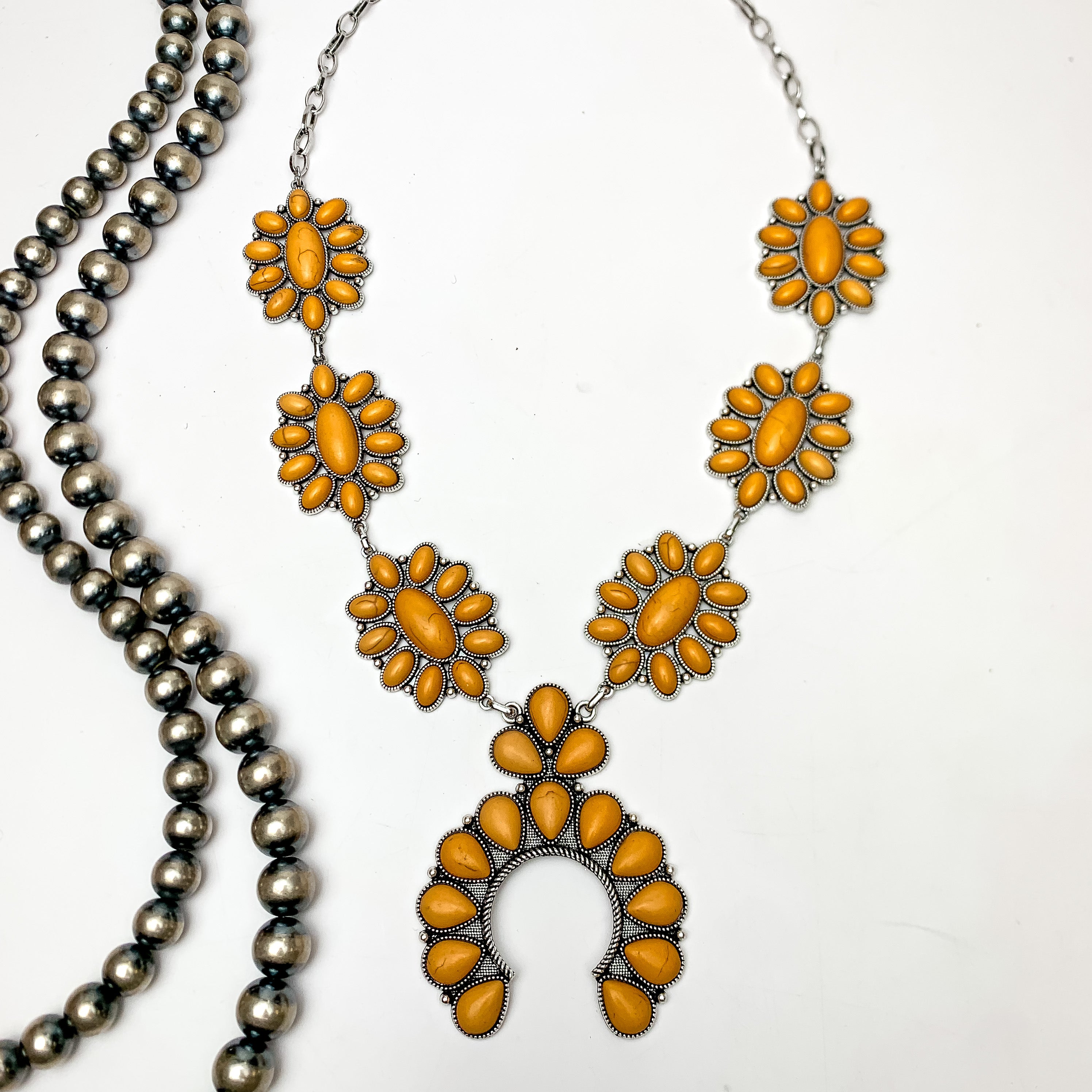 Squash Necklace with Oval Flowers in Silver Tone and yellow. This necklace is pictured on a white background with Navajo pearls on the left side.