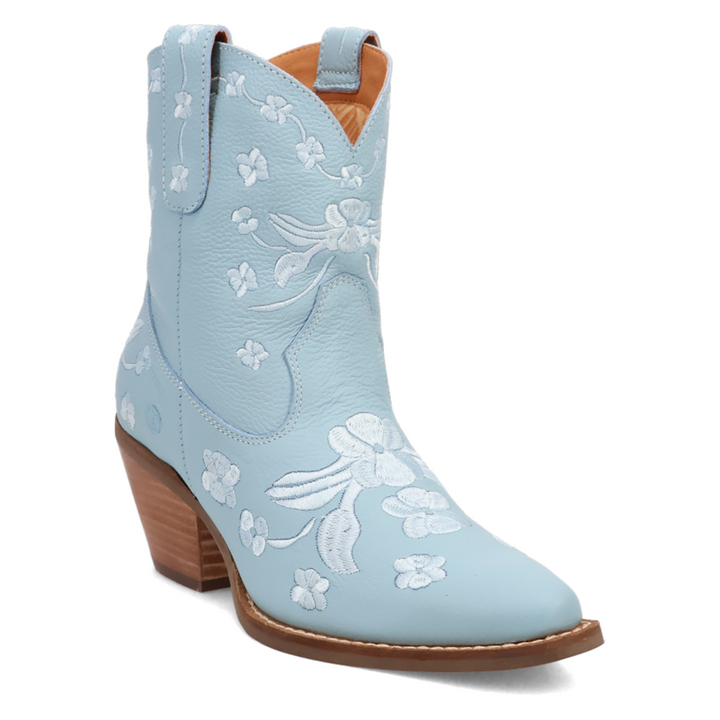 Short blue leather western boot with a rounded pointed toe, soft floral embroidery throughout the shaft and foot, stitching, side pull tabs, and a medium 2 inch stacked wooden heel. Feminine and flirty with a vintage cowgirl twist.