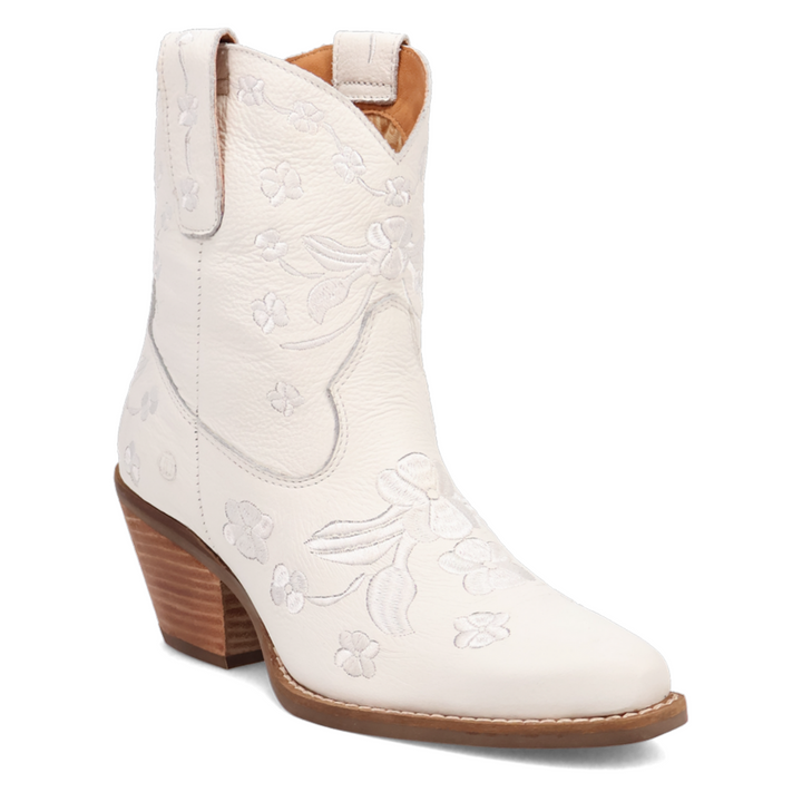 Short white leather western boot with a rounded pointed toe, soft floral embroidery throughout the shaft and foot, stitching, side pull tabs, and a medium 2 inch stacked wooden heel. Feminine and flirty with a vintage cowgirl twist