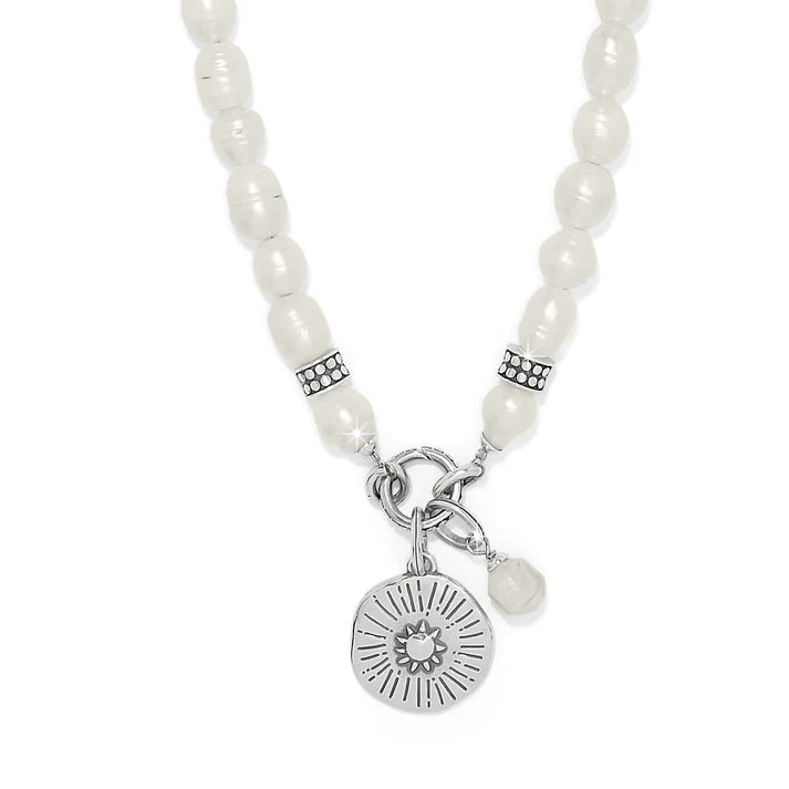 Pearl necklace with a silver charm on a white background