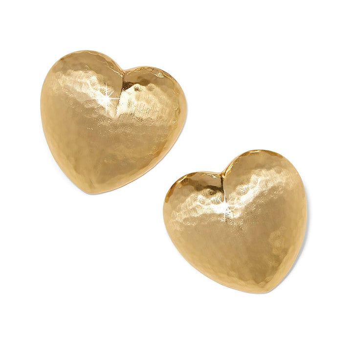 A solid white background. Gold shiny hammered heart earrings. 