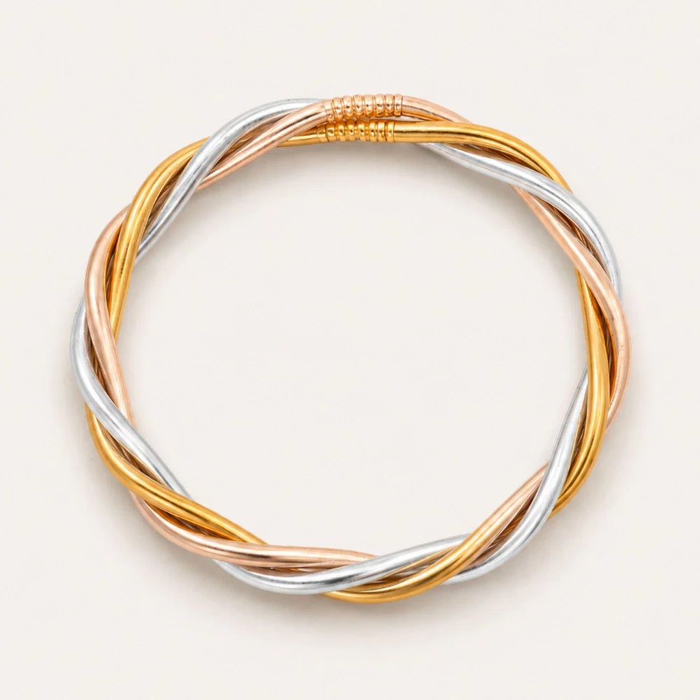 Tri-color braided bracelet on a light beige background