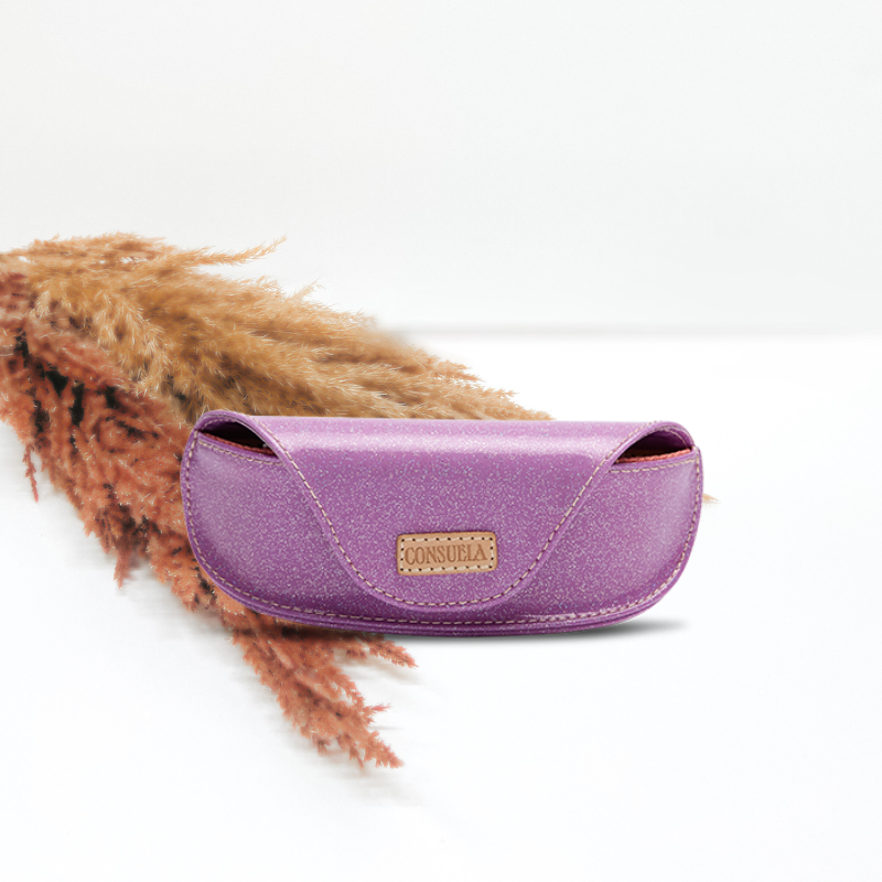 white background with decorative grass for a fun touch featuring a purple glitter consuela cloth sunglass case