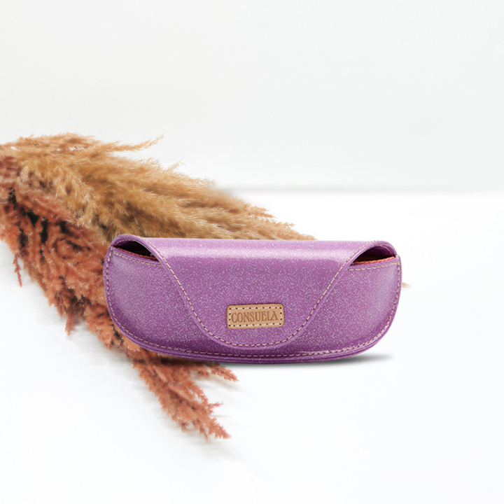 white background with decorative grass for a fun touch featuring a purple glitter consuela cloth sunglass case