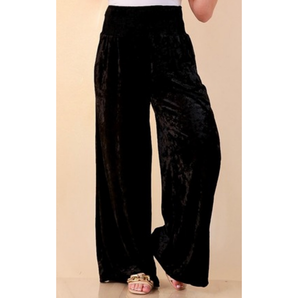 Full length image of a woman wearing the Velvet Hour Smocked Waist Crushed Velvet Wide Leg Pants in Black