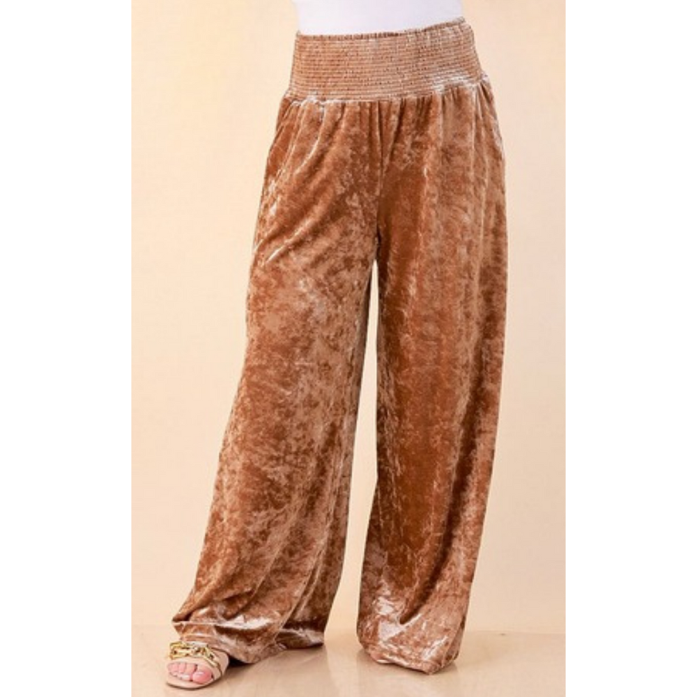 Full length image of a woman wearing the Velvet Hour Smocked Waist Crushed Velvet Wide Leg Pants in Champagne