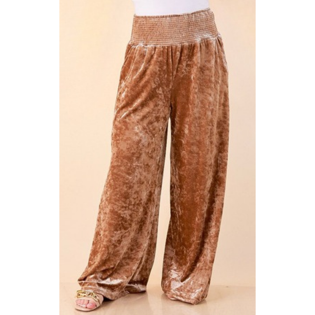 Full length image of a woman wearing the Velvet Hour Smocked Waist Crushed Velvet Wide Leg Pants in Champagne