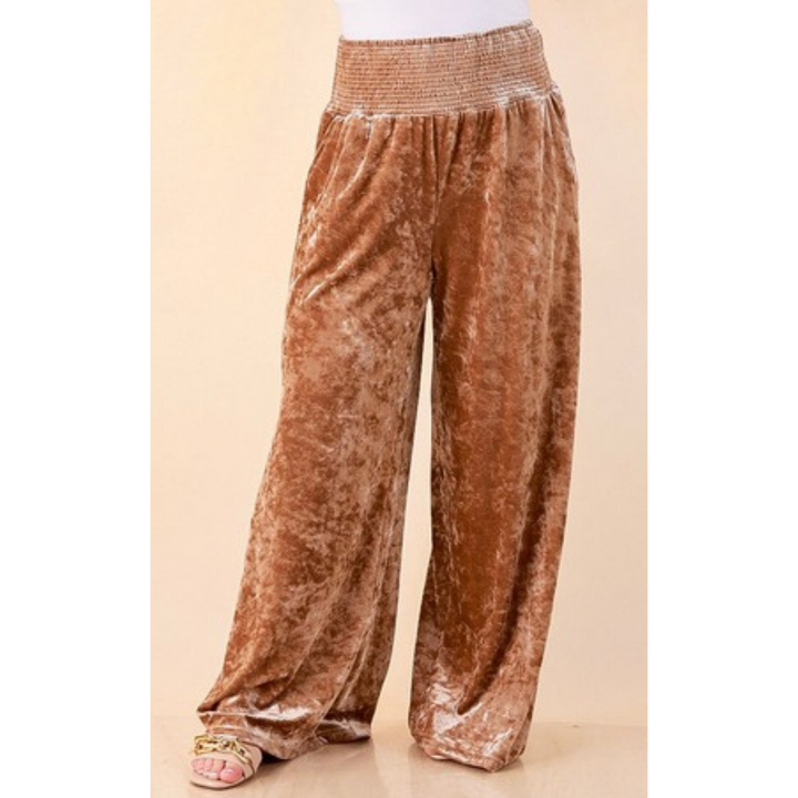 Full length image of a woman wearing the Velvet Hour Smocked Waist Crushed Velvet Wide Leg Pants in Champagne