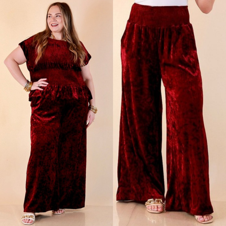 Two images of a woman wearing the Velvet Hour Smocked Waist Crushed Velvet Wide Leg Pants in Maroon on a beige background