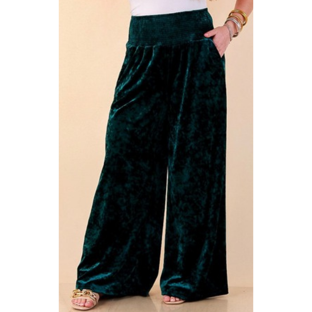 Full length image of a woman wearing the Velvet Hour Smocked Waist Crushed Velvet Wide Leg Pants in Teal