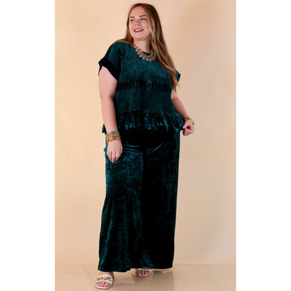 Full length image of a woman wearing the Velvet Hour Smocked Crushed Velvet Cap Sleeve Peplum Top in Teal