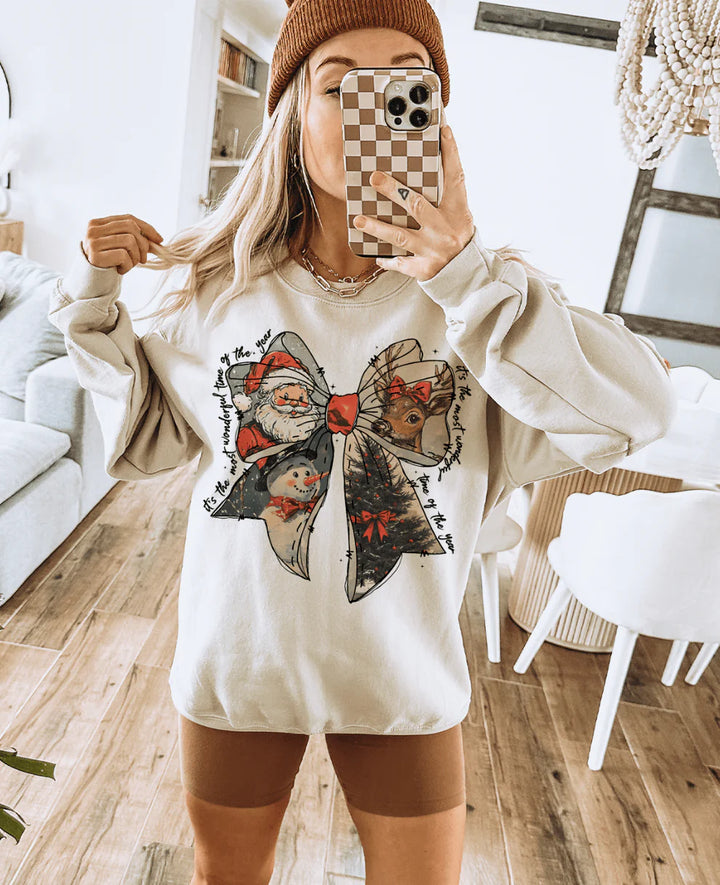 Cream sweatshirt with retro Christmas bow design and “It’s the most wonderful time of the year” text