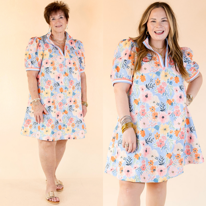 v neck short floral print dress with a v neck, short puff sleeves, stripe detailing on the neckline and end of sleeves. Featuring a plus size model, this dress currently only comes in plus sizes.