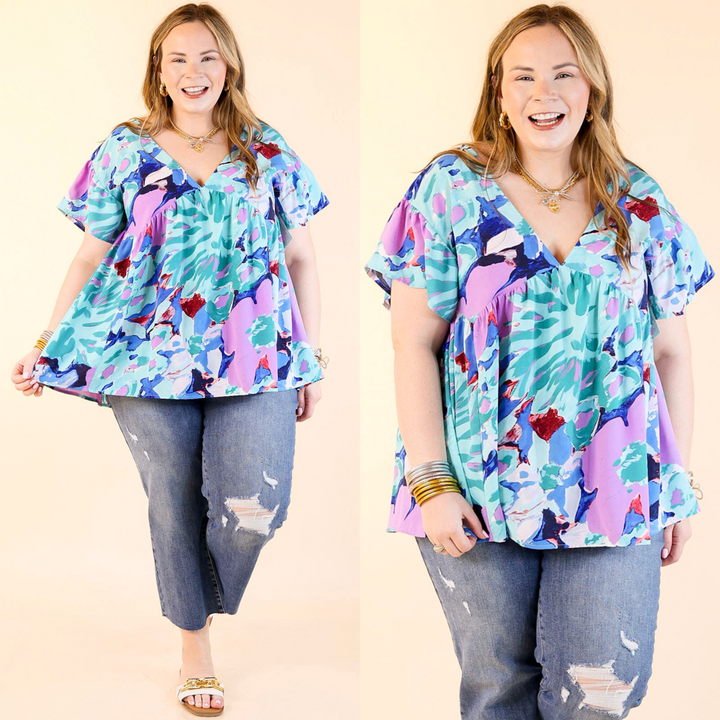 Top includes a v neckline, a watercolor floral print, a tie on the upper back, and a tropical vibe! Available in sizes small through plus size.