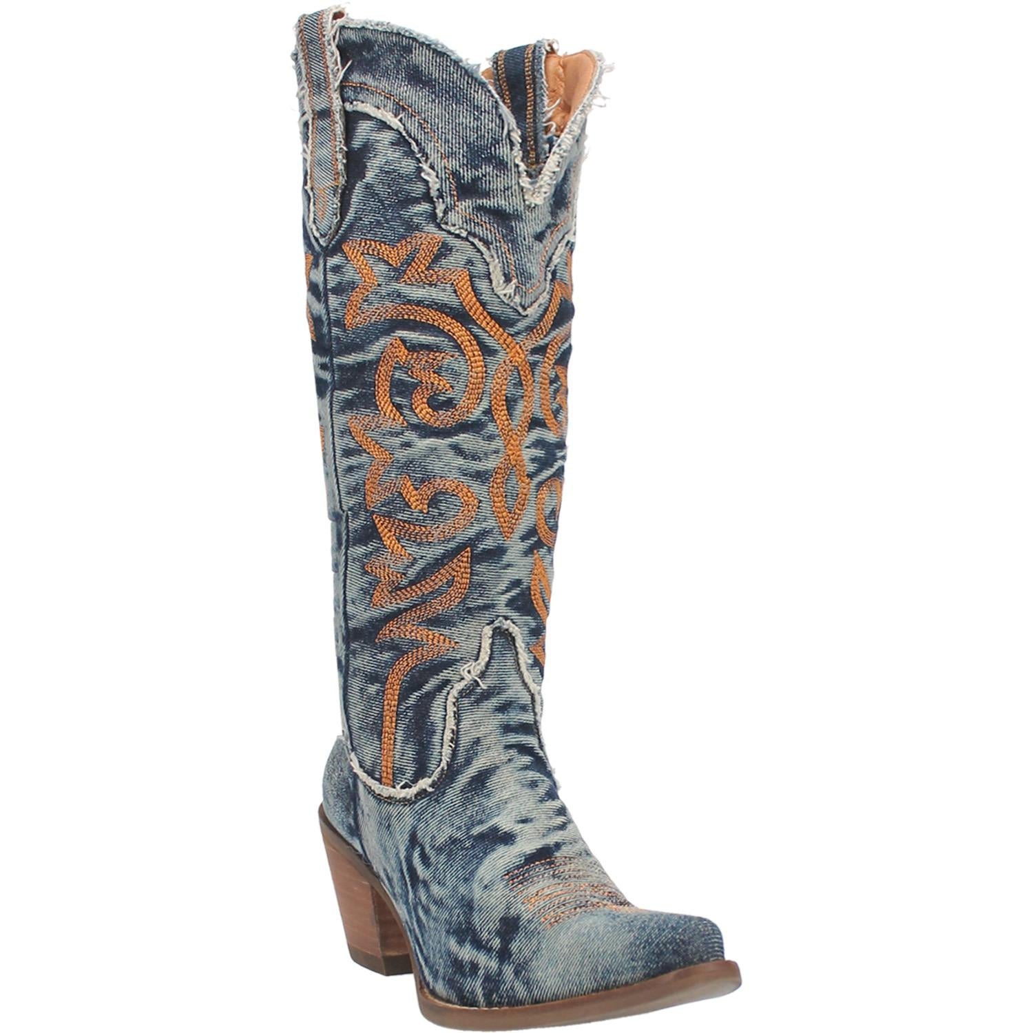 A mid calf length denim boot with a short heel, gold stitch design across the front, straps, and V cut at the top. Item is pictured on a white background.