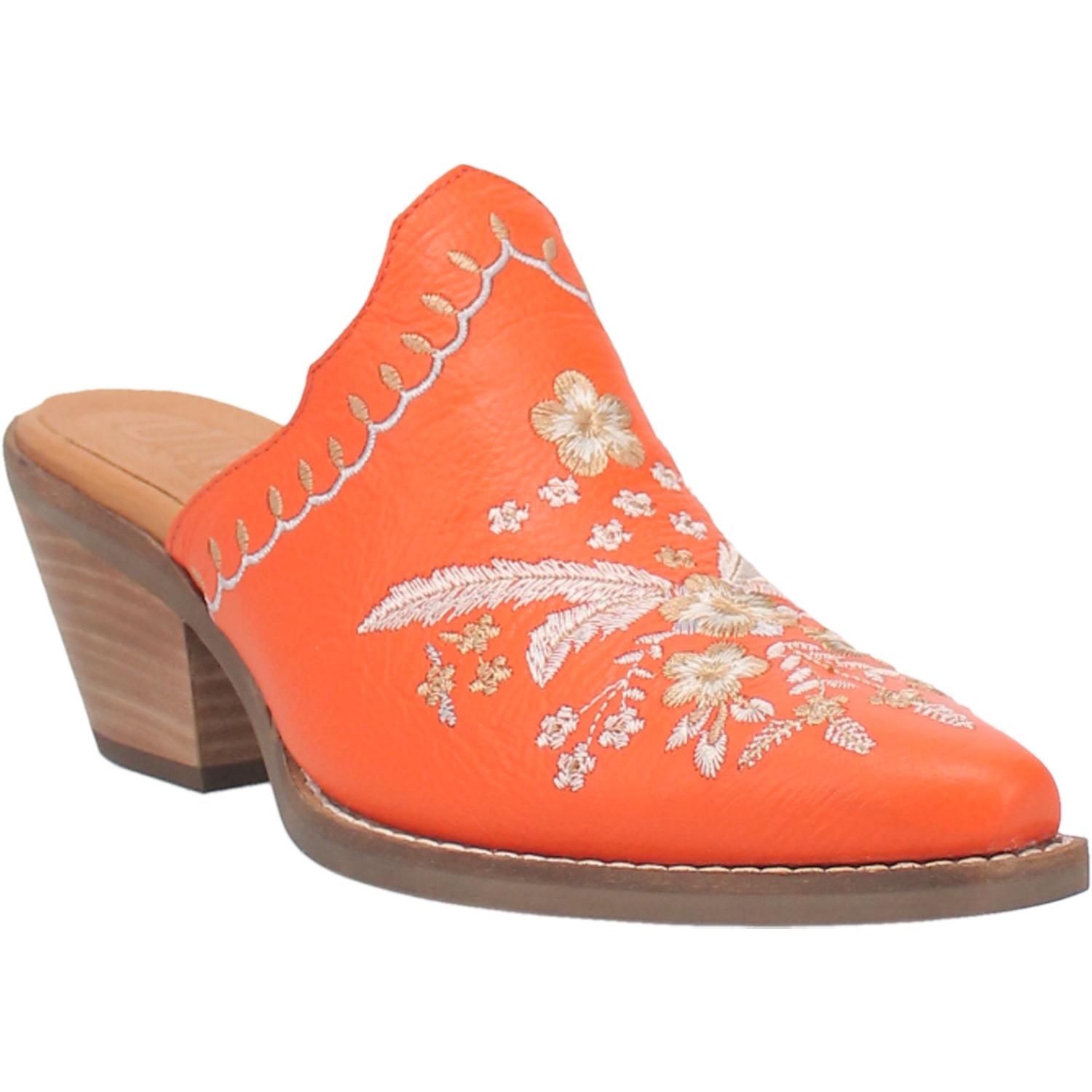 An orange bootie with a white  and cream floral and feather design on the upper, a white and cream stitched design on the edge, and a short heel
