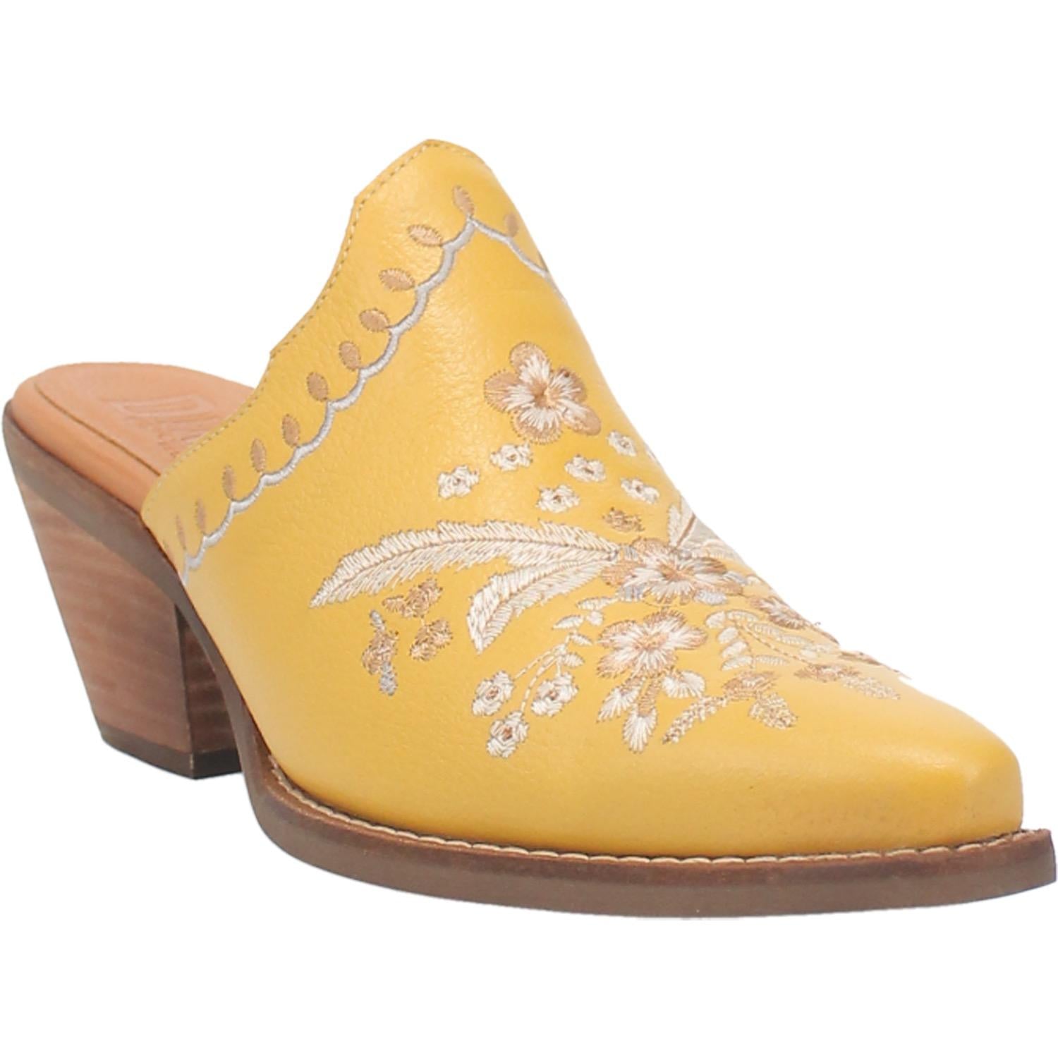 A yellow bootie with a white floral and feather design on the upper, a white stitched design on the edge, and a short heel