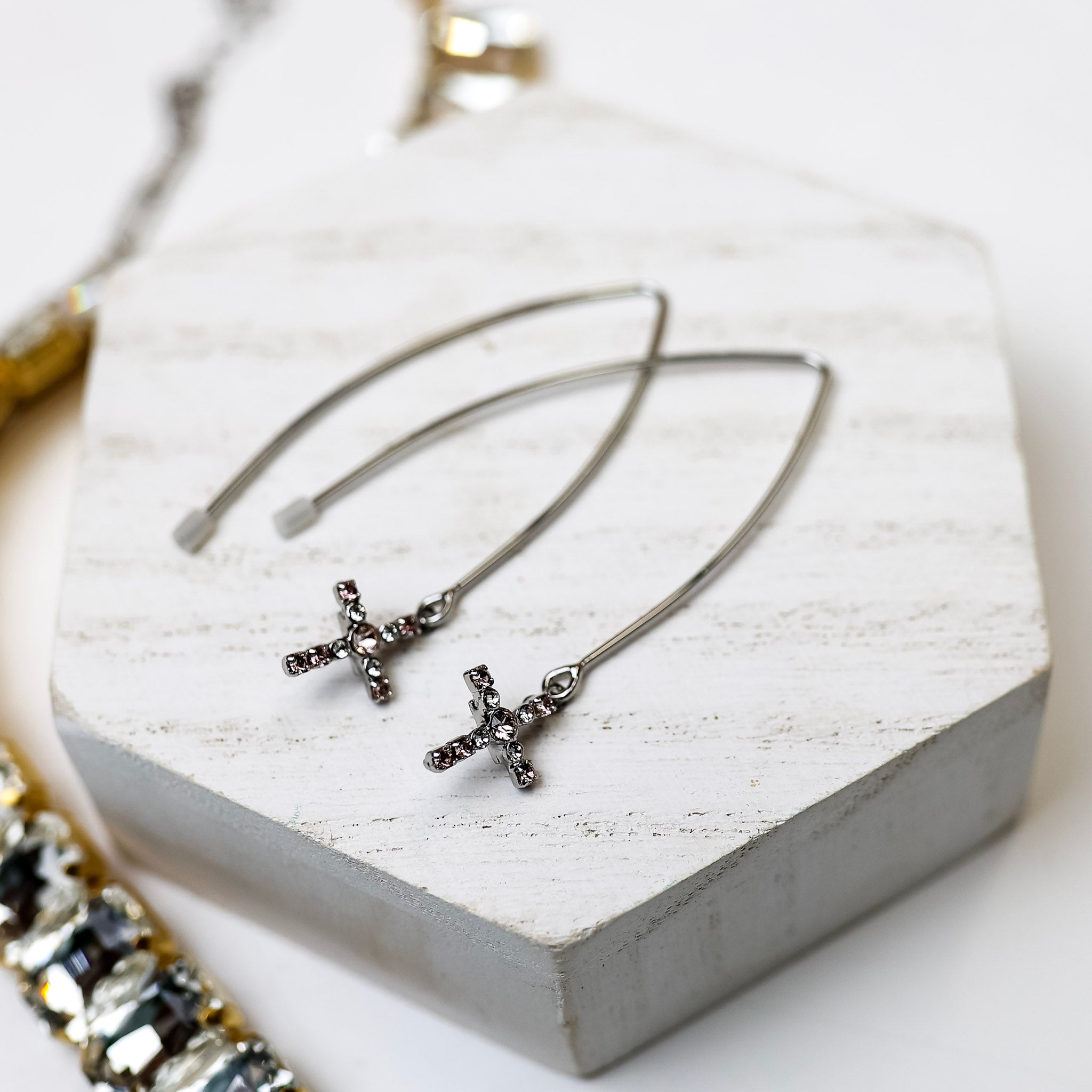 A pair of silver-tone dangle earrings with crystal Cross pendants.