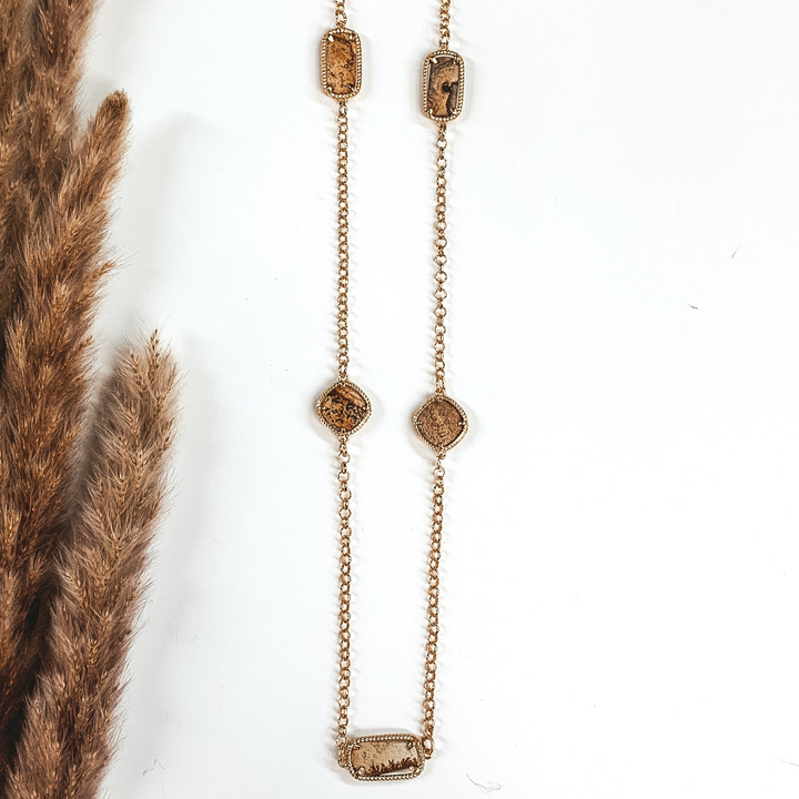 mixed brown stones on a long gold necklace