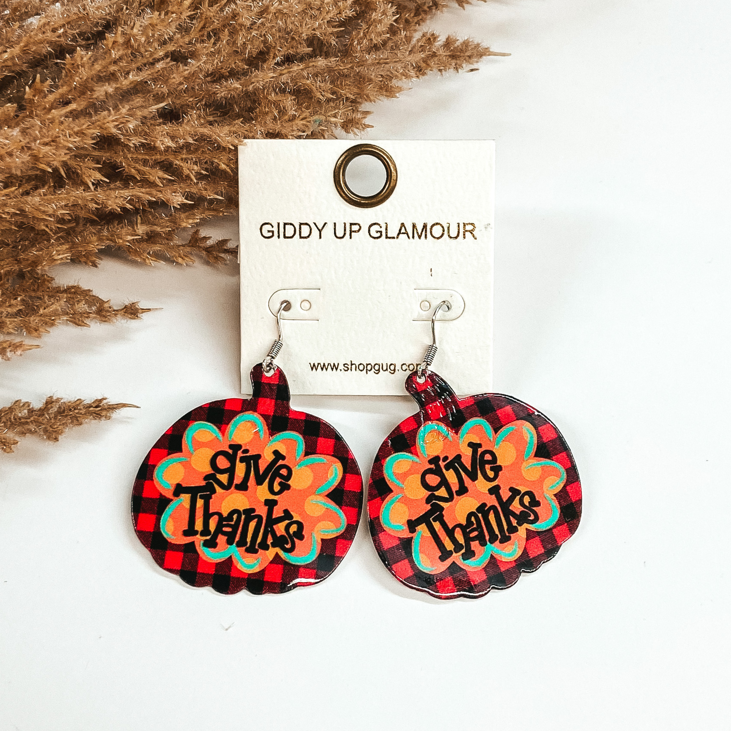 red buffalo plaid pumpkin earring with give thanks written in the middle