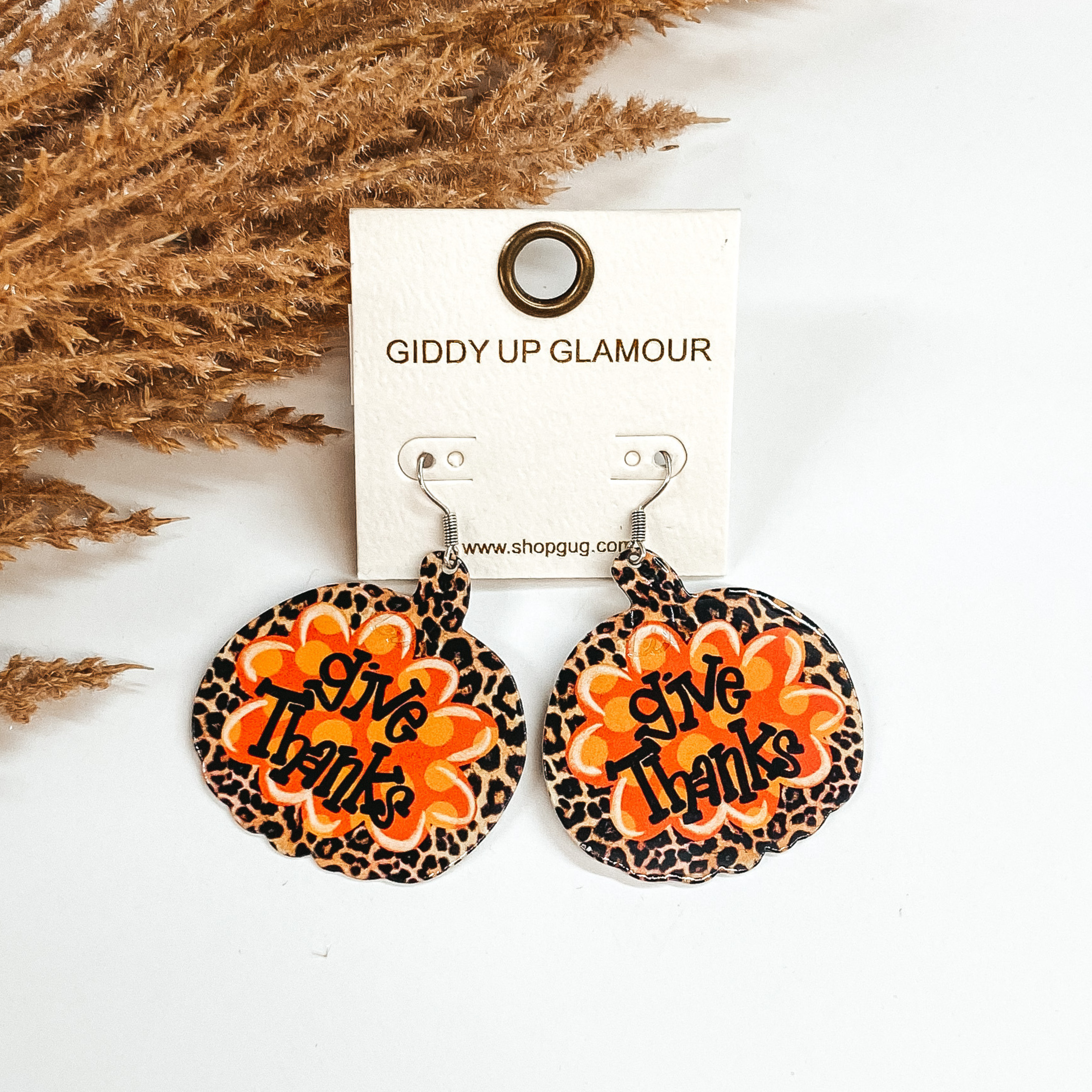 leopard pumpkin earrings with give thanks written in the middle 