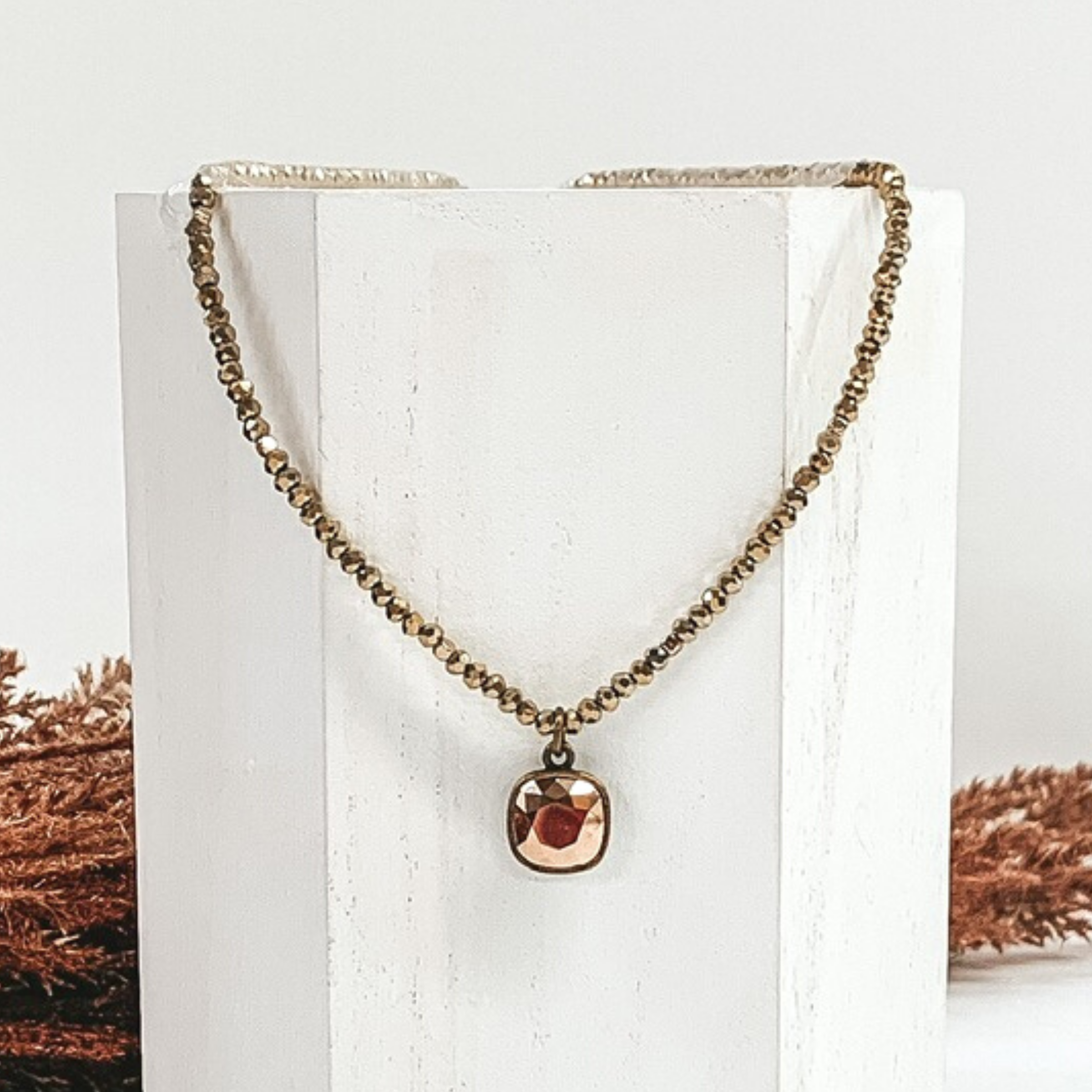 bronze beaded necklace with rose gold crystal charm