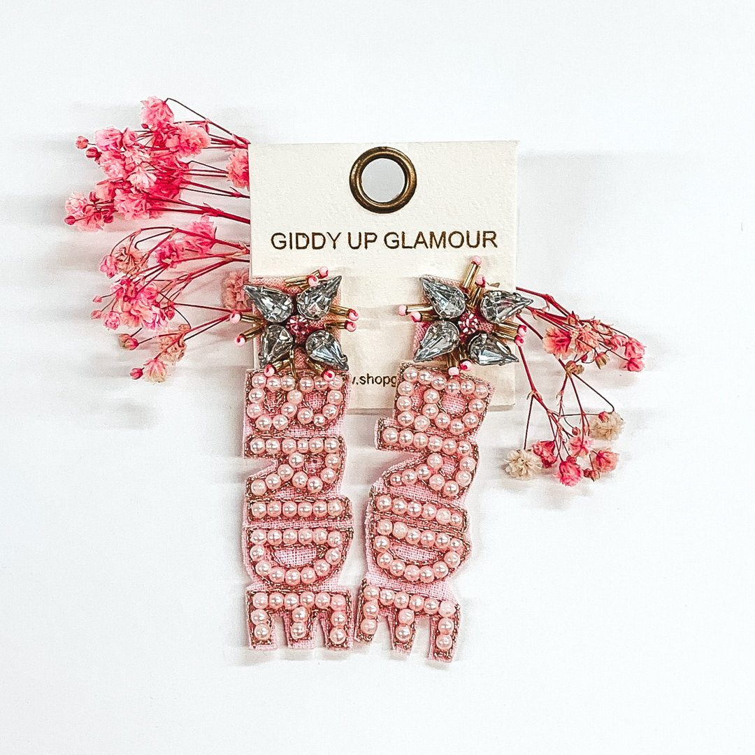 crystal cluster studs with light pink beaded "bride" hanging down from the cluster