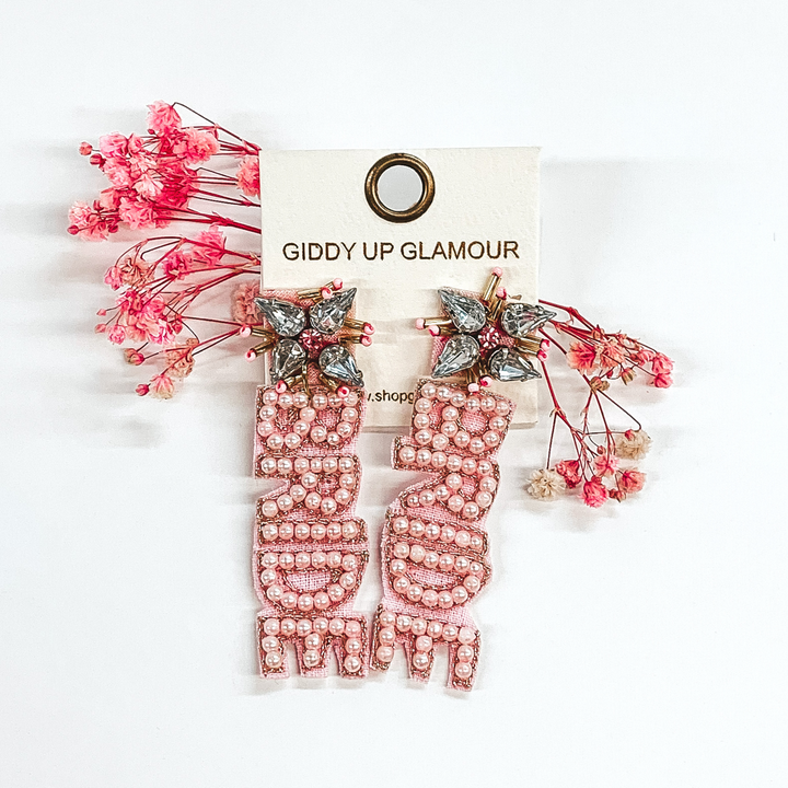 crystal cluster studs with light pink beaded "bride" hanging down from the cluster