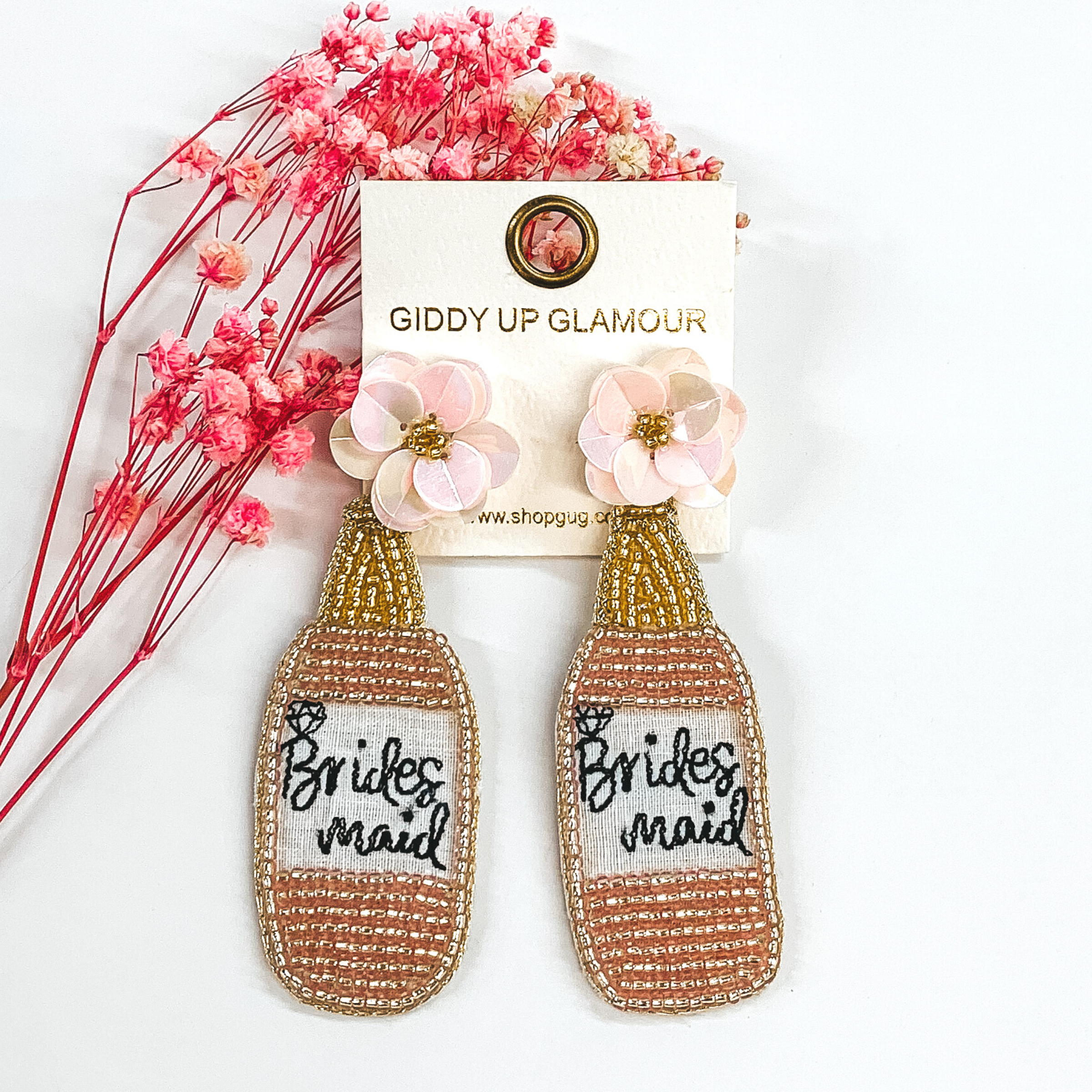 pink and gold beaded champagne bottles with bridesmaid written in the center and light pink flower studs
