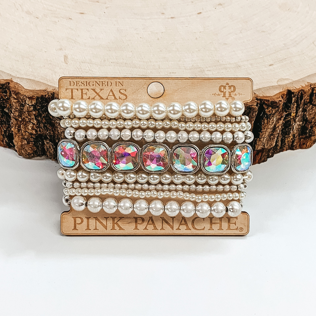 This bracelet set includes white and silver beaded bracelets in different sizes and also has a square ab crystal beaded bracelet. 