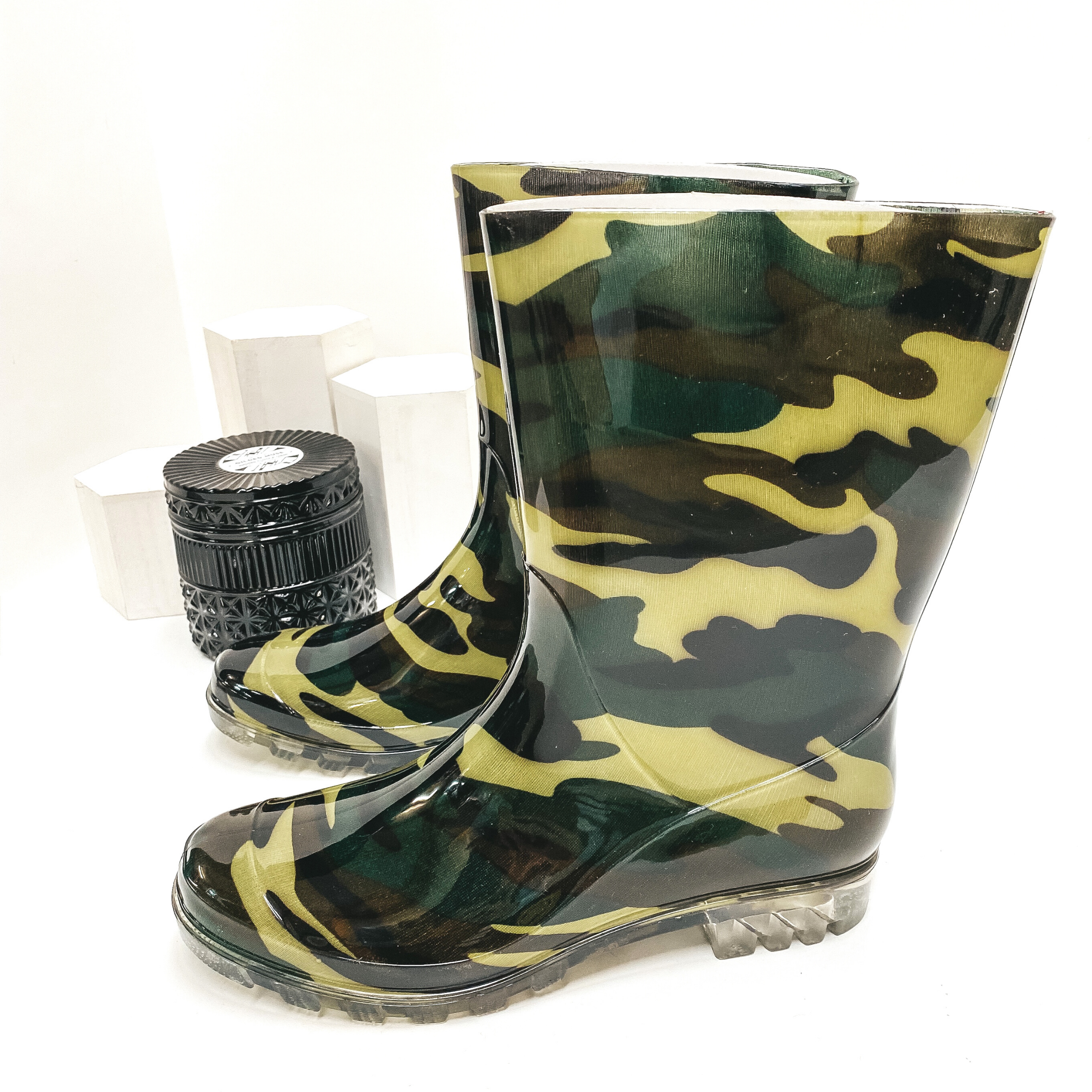 Green camouflage calf high rubber boots. Pictured on white background.