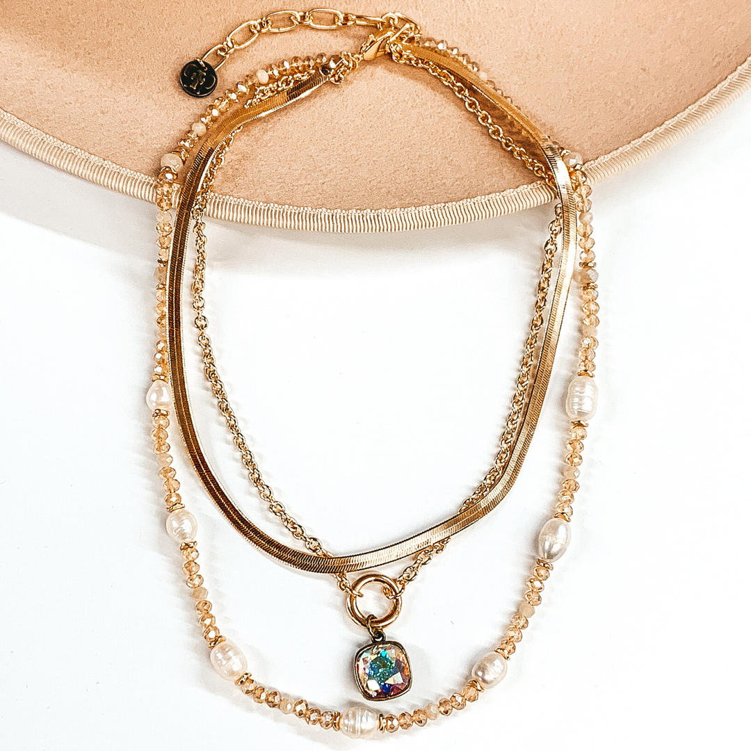 Pink Panache | Three Strand Pearl and Tan Beaded Necklace with Gold Chains and AB Cushion Cut Crystal Drop - Giddy Up Glamour Boutique
