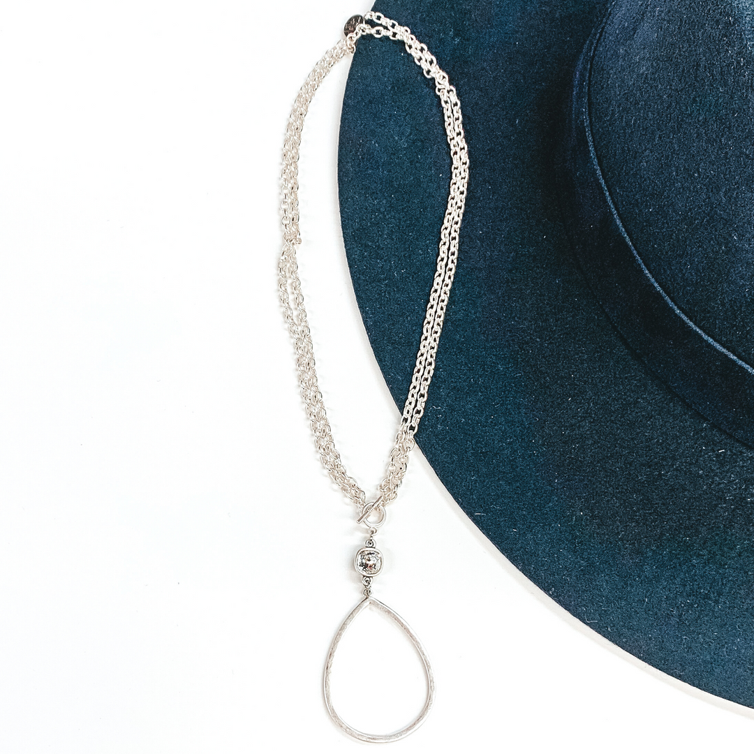 Pink Panache | Silver Open Teardrop Pendant with Clear Cushion Cut Crystal on a Double Silver Chained Necklace with Toggle Front - Giddy Up Glamour Boutique