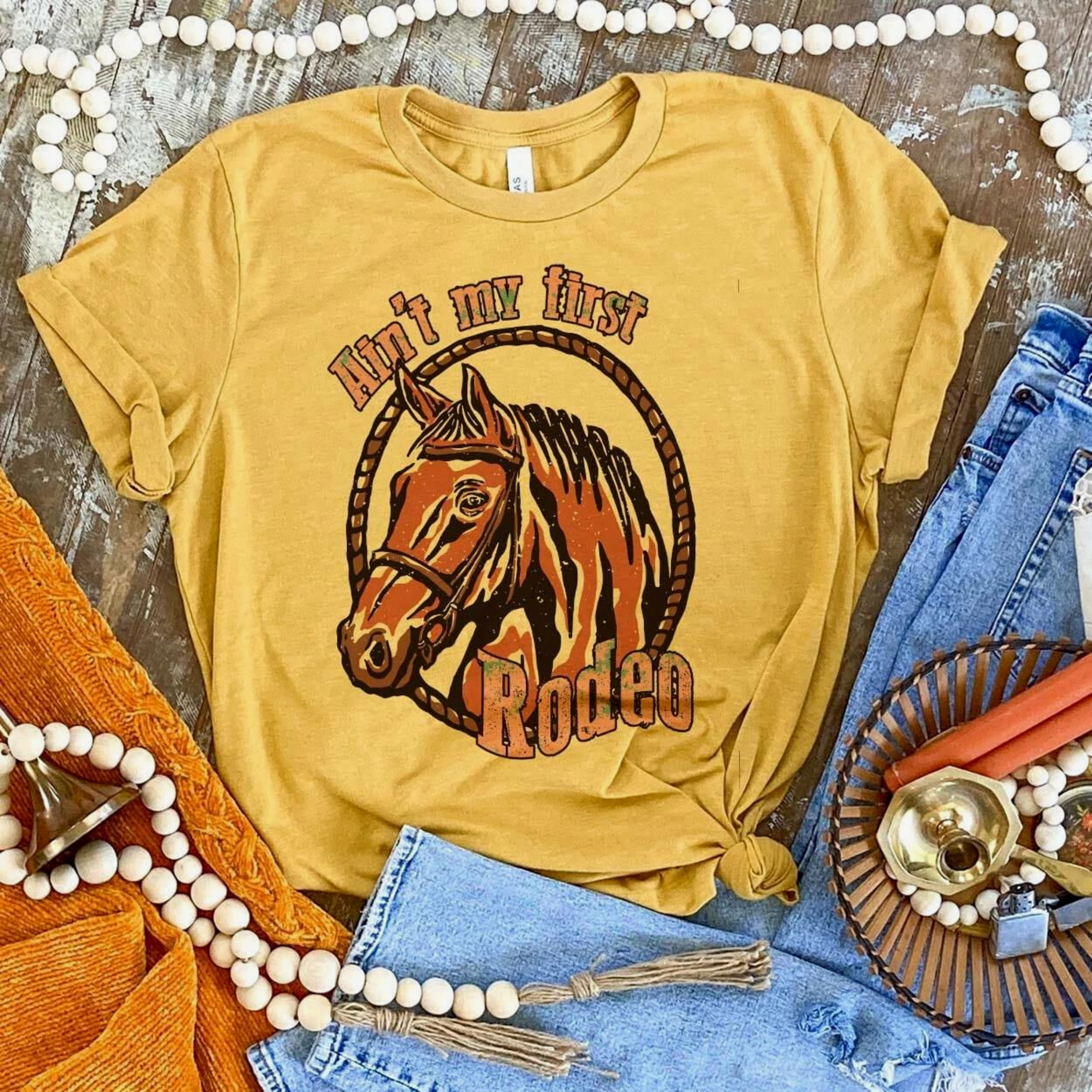Online Exclusive | Ain't My First Rodeo Short Sleeve Graphic Tee in Mustard Yellow - Giddy Up Glamour Boutique