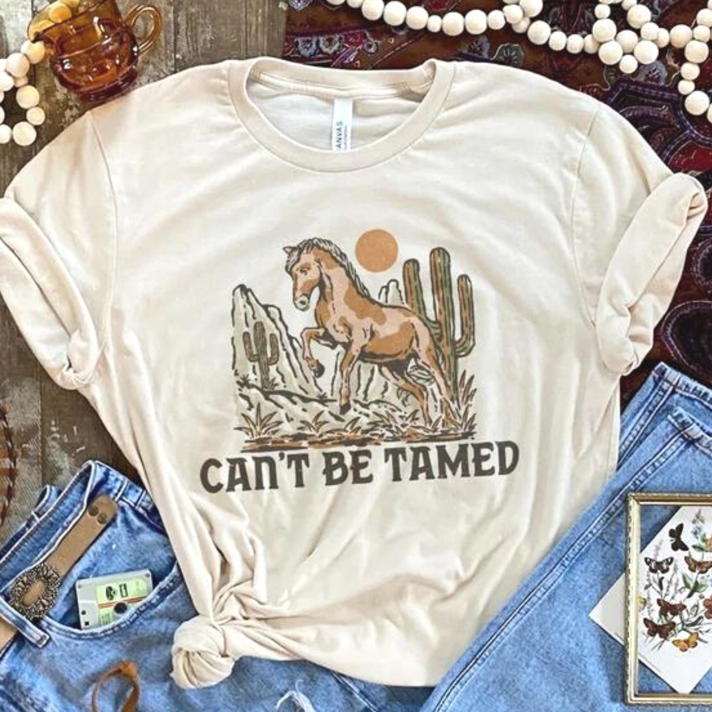 Online Exclusive | Can't Be Tamed Short Sleeve Graphic Tee in Cream - Giddy Up Glamour Boutique