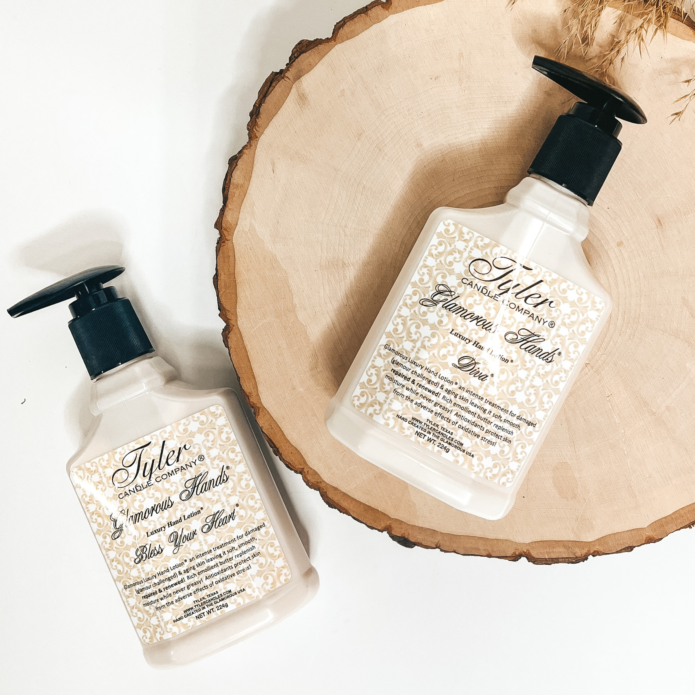 Glamourous hand lotion pictured in 8 oz size of Bless Your Heart and Diva scent pictured on tree wood with a Tyler logo.