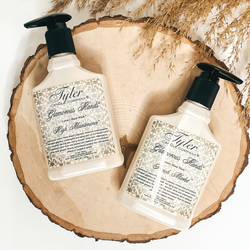 Glamourous hand wash pictured in 8 oz size of High Maintenance and French Market scent pictured on tree wood with a Tyler logo.