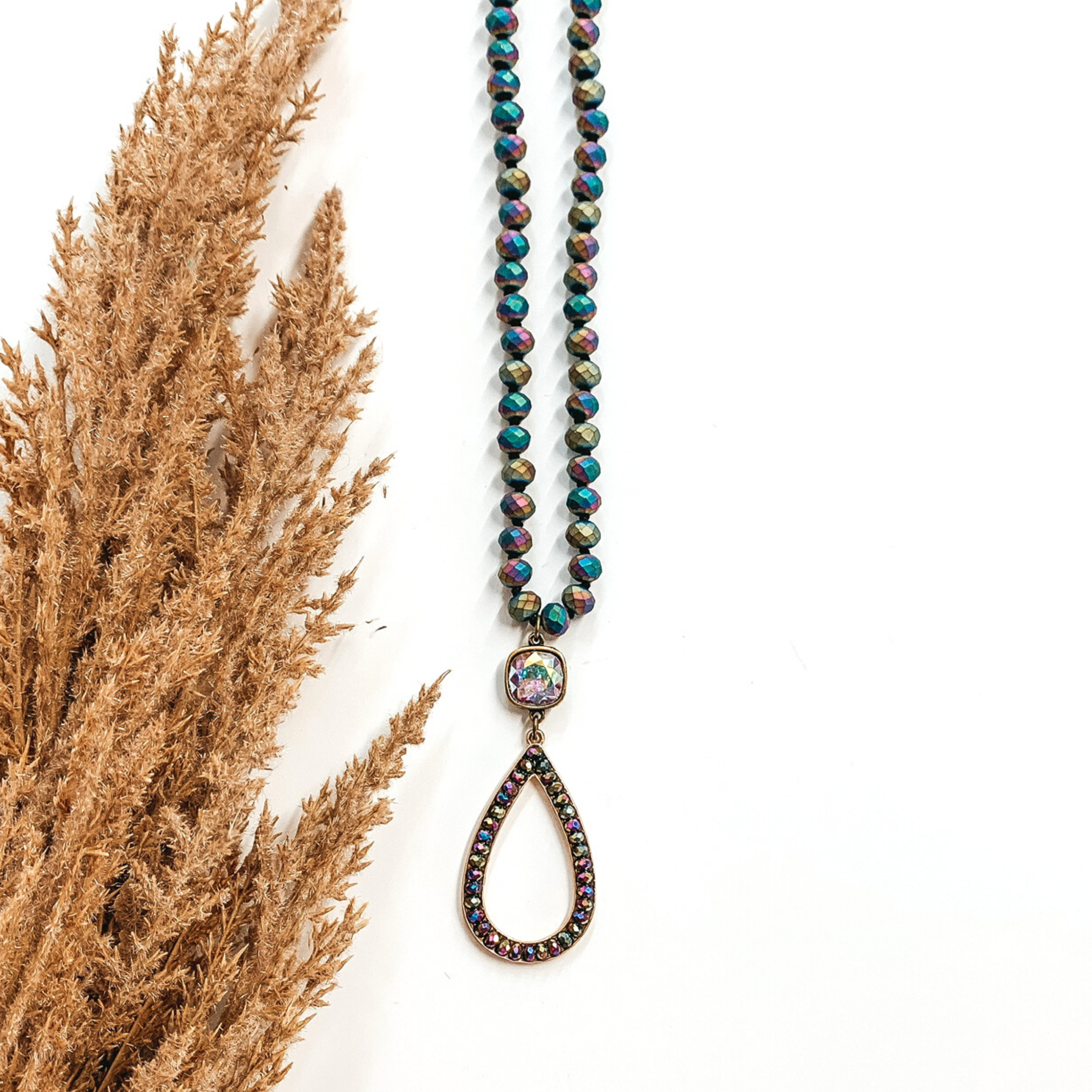 dark colorful long necklace in purples with ab crystal charm and teardrop pendant 