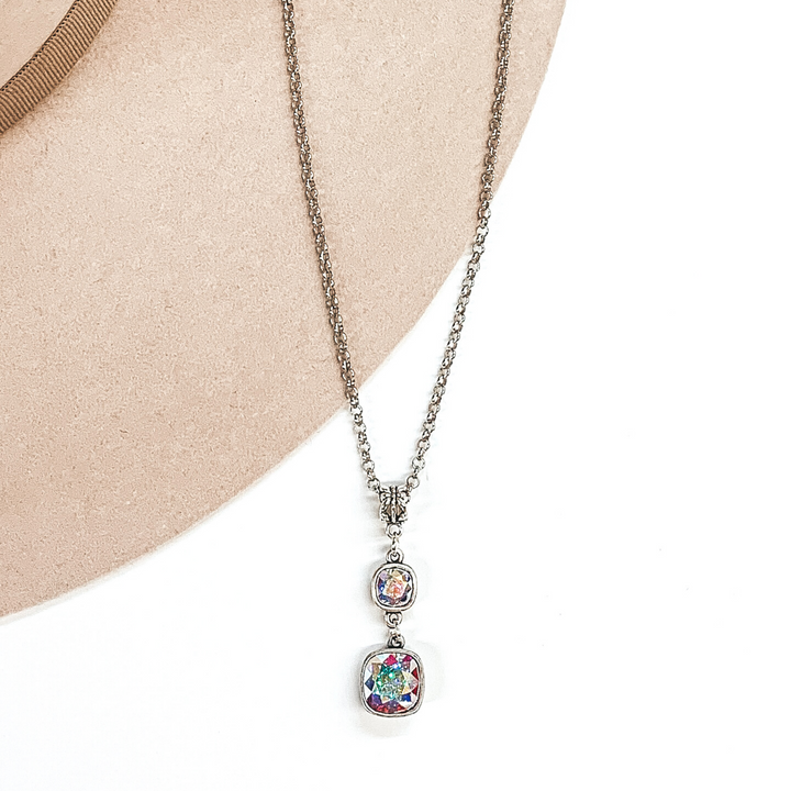 Silver adjsutable chained necklace with 2 square AB stone pendant on a white and beige background