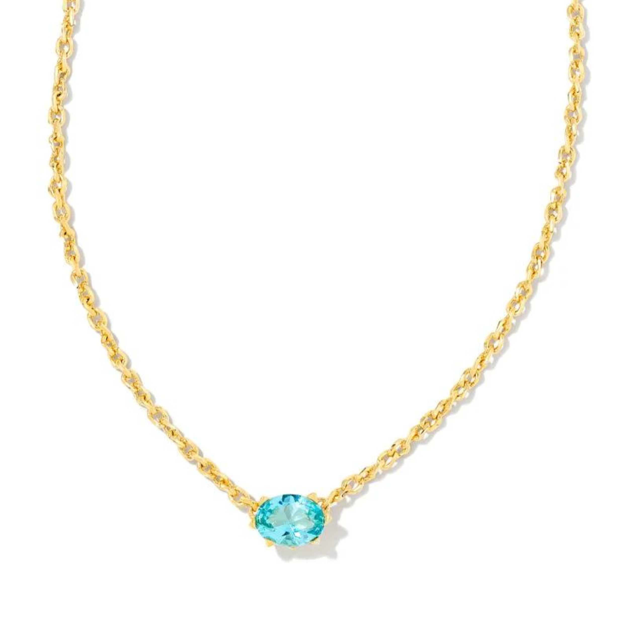 Gold chain necklace with am aqua crystal pendant, pictured on a white background.