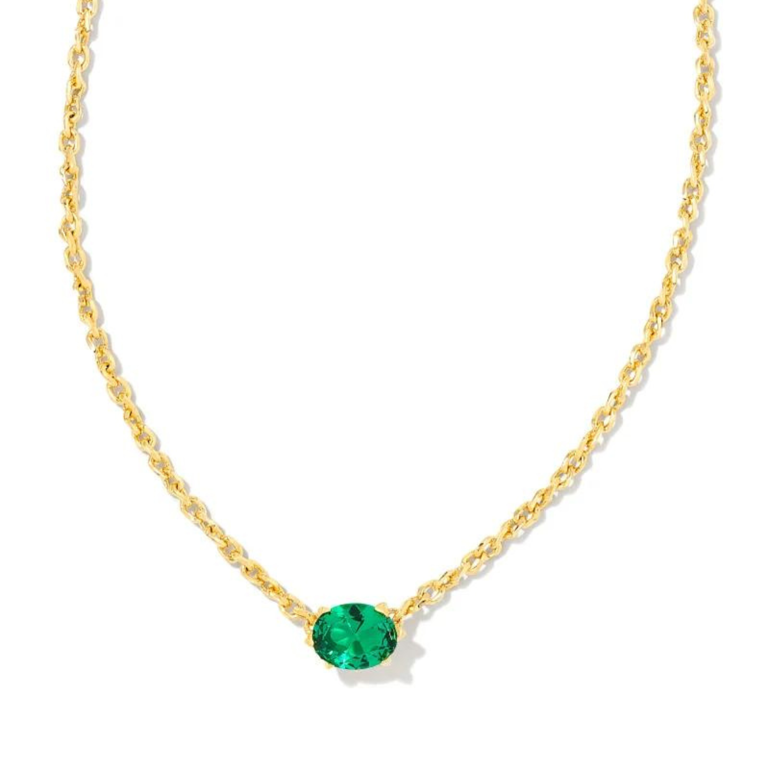 Gold chain necklace with a green crystal pendant, pictured on a white background.