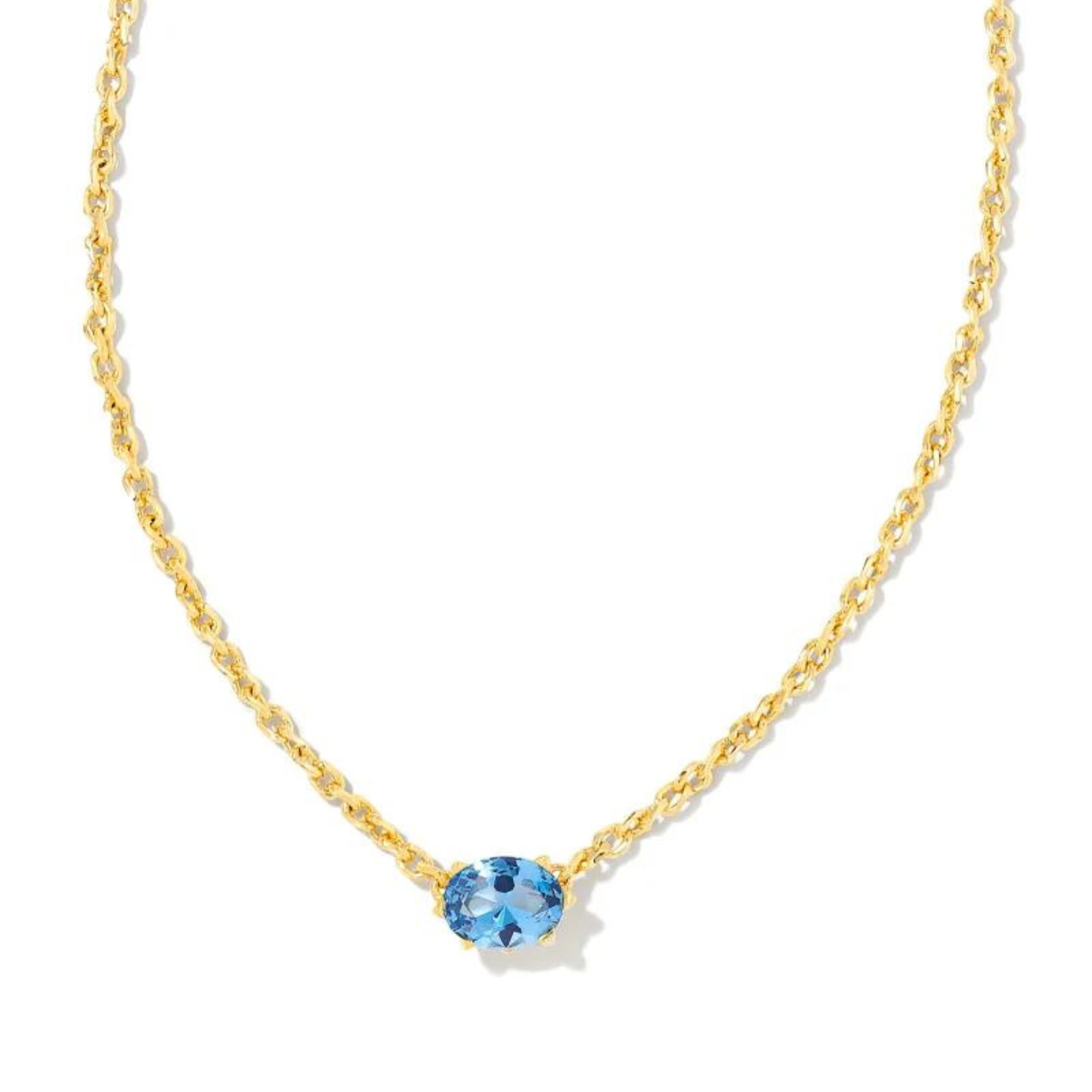 Gold chain necklace with a blue violet crystal pendant, pictured on a white background.