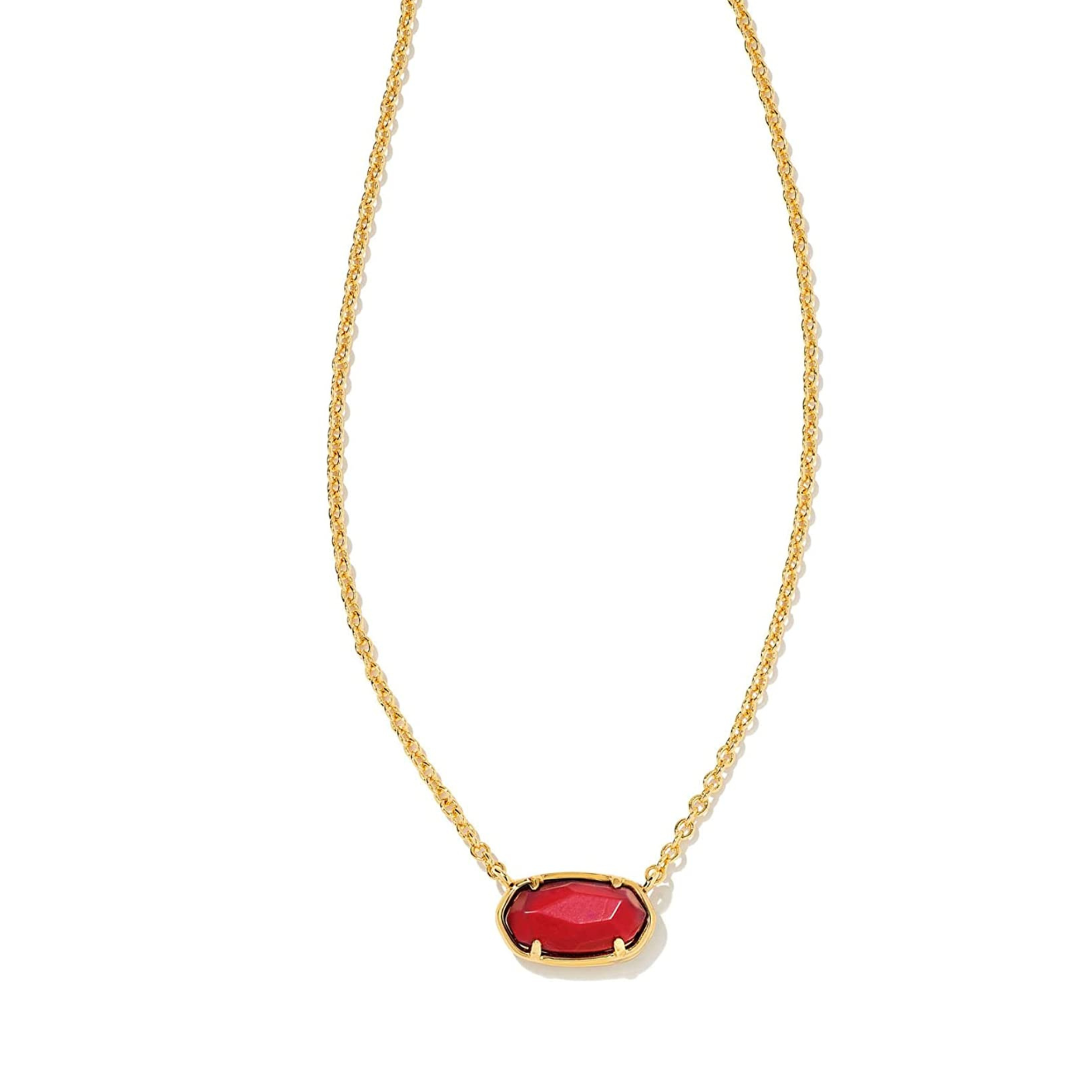 Gold chain necklace with maroon magnesite pendant, pictured on a white background.