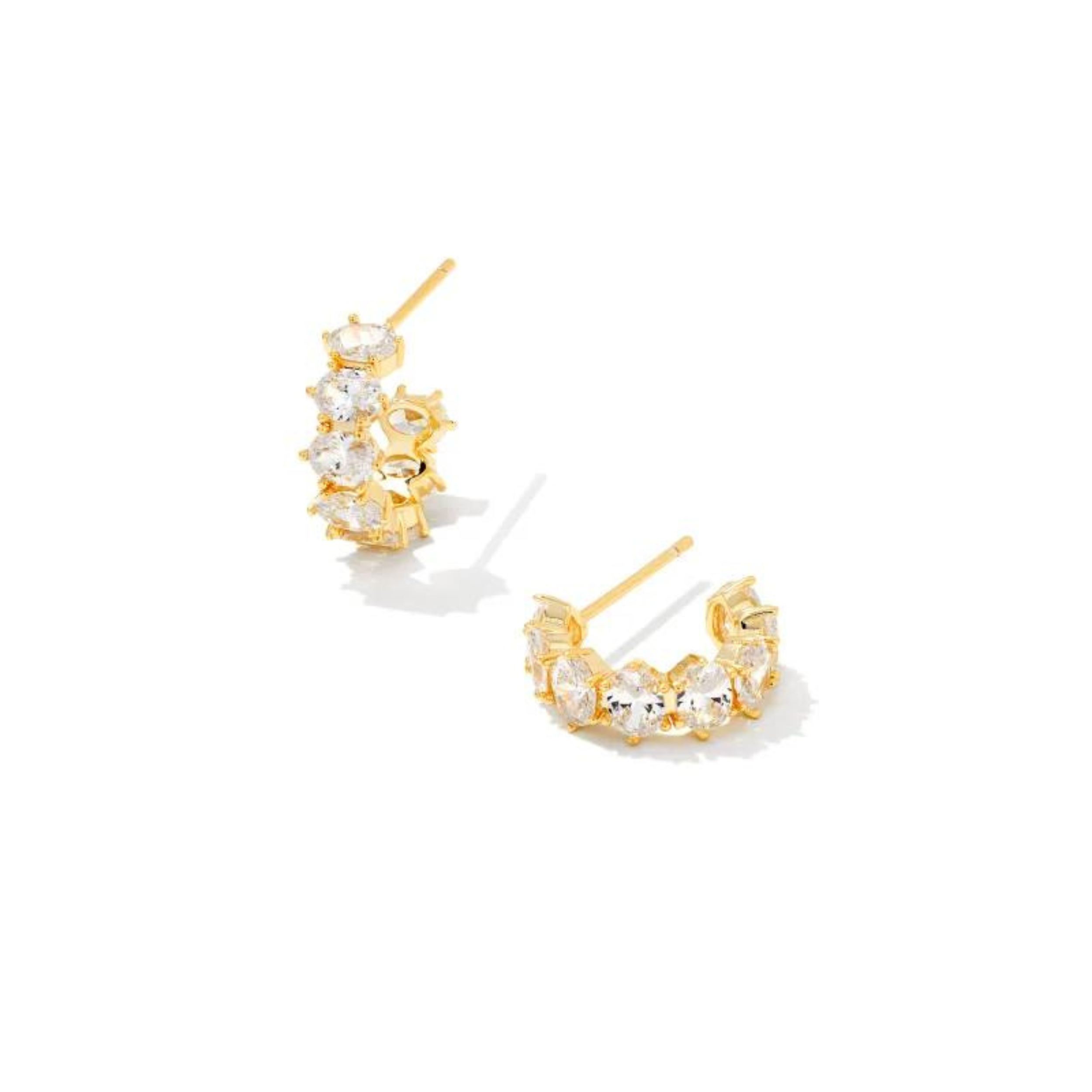 Gold crystal huggie earrings, pictured on a white background.